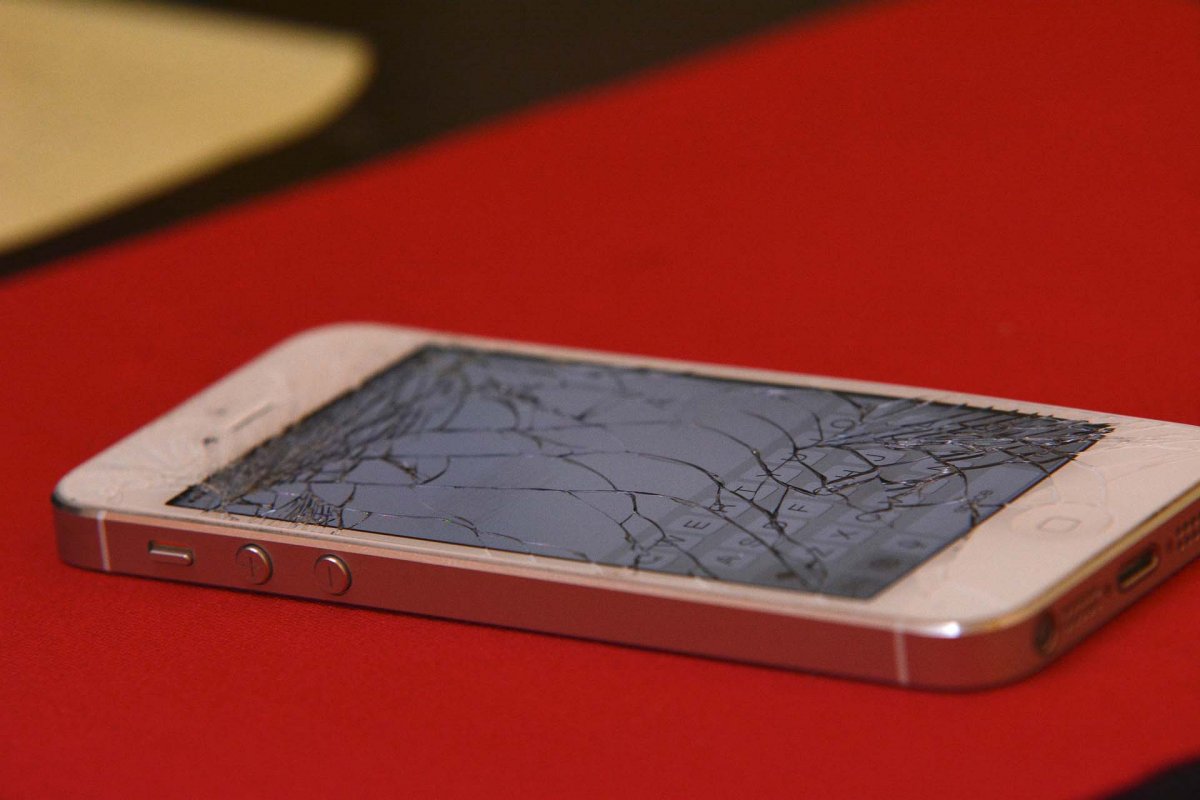 An iPhone 5 with a broken screen.