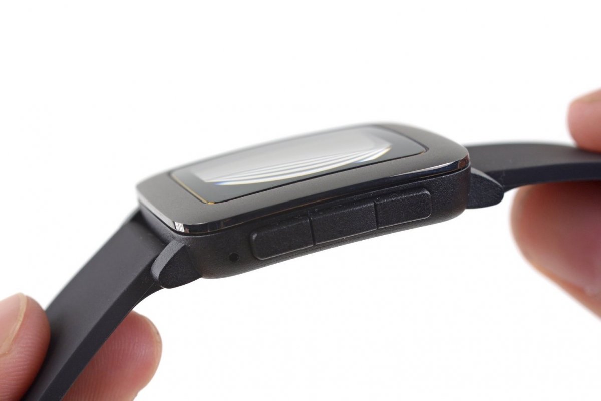 Fingers holding up the Pebble Time against a white background