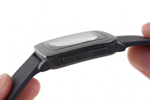 Fingers holding up the Pebble Time against a white background