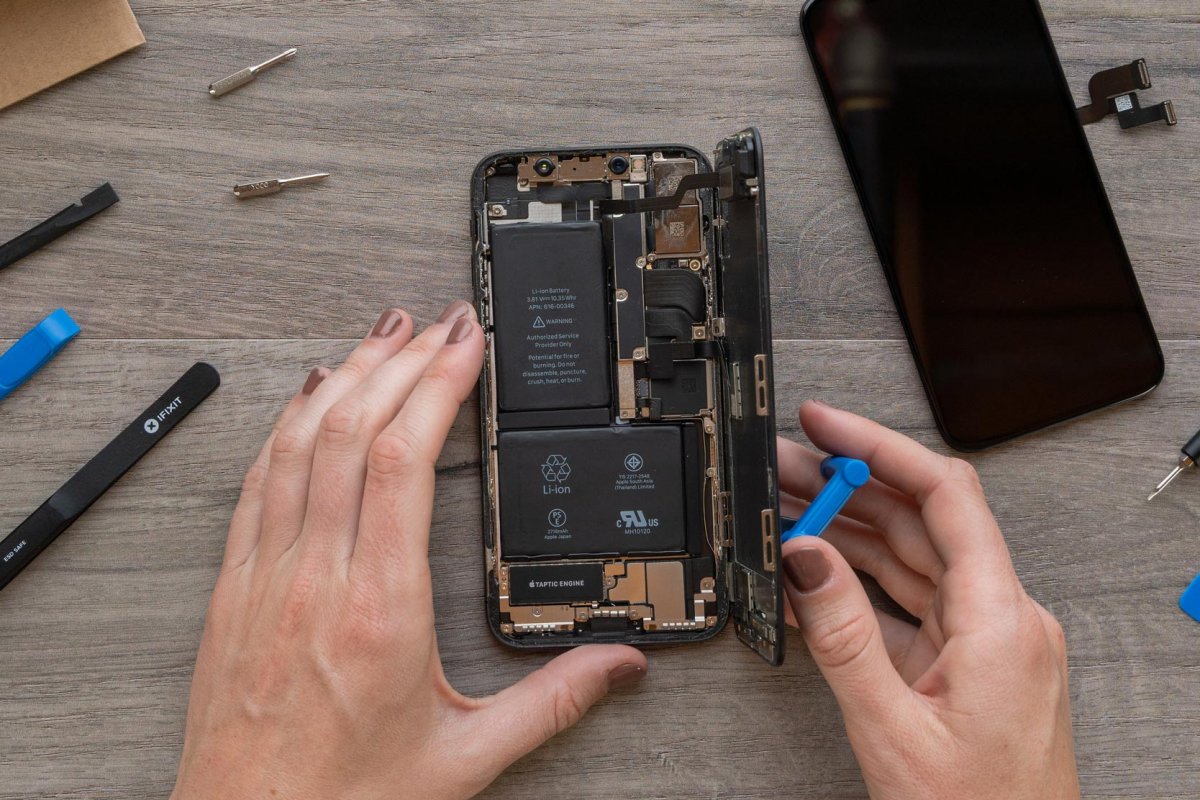 A golden iPhone X, open on the table.