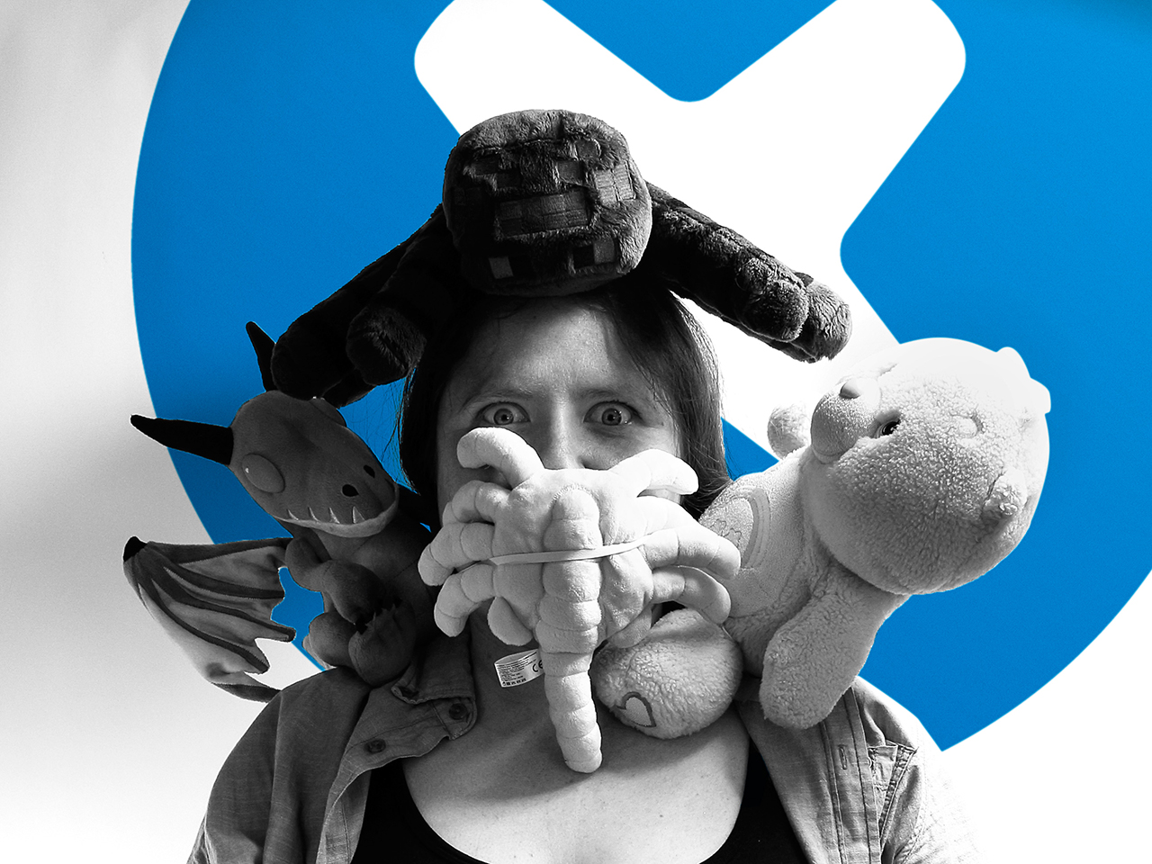 Raven surrounded by stuffed animals.