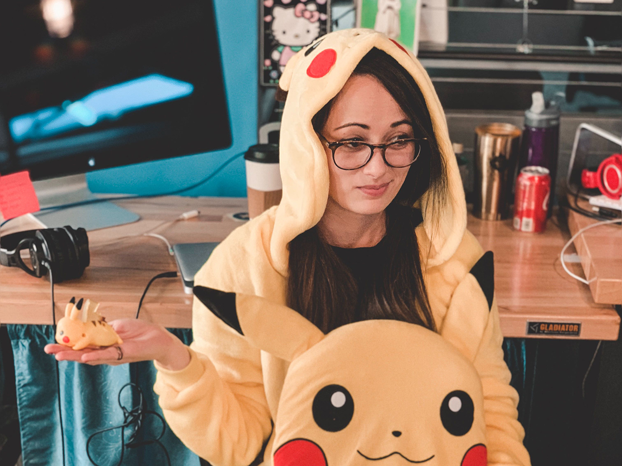 Kay-Kay dressed as Pikachu, holding two pickachus