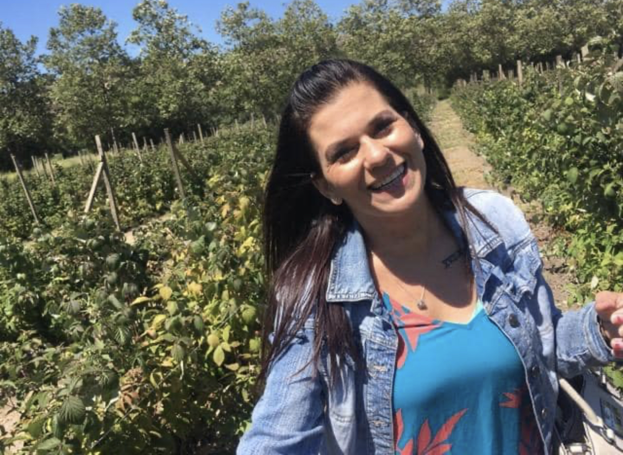 Tiffani grinning in a field