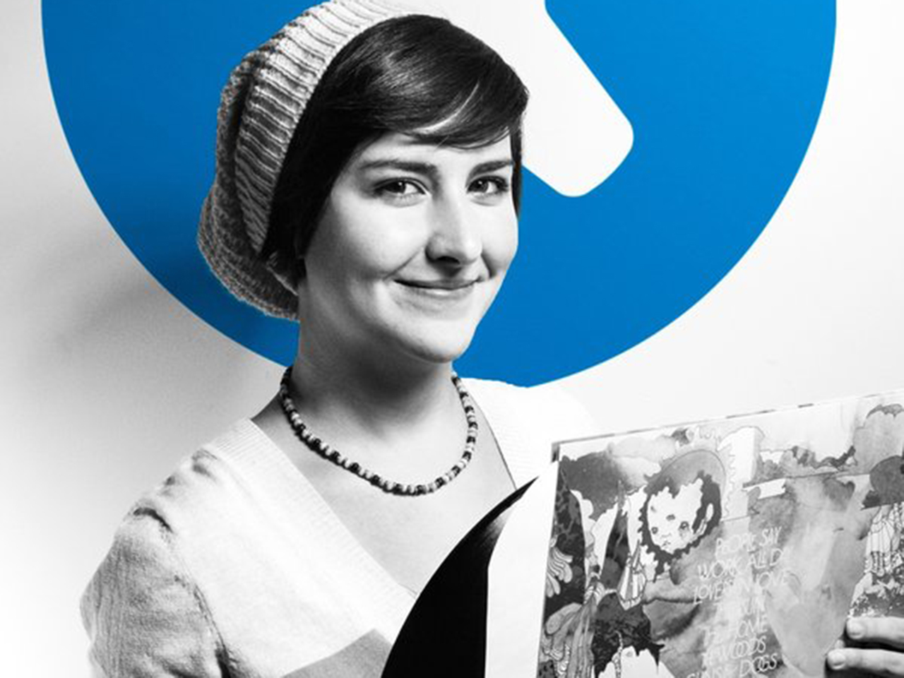 Kristen holding a vinyl in front of the iFixit logo