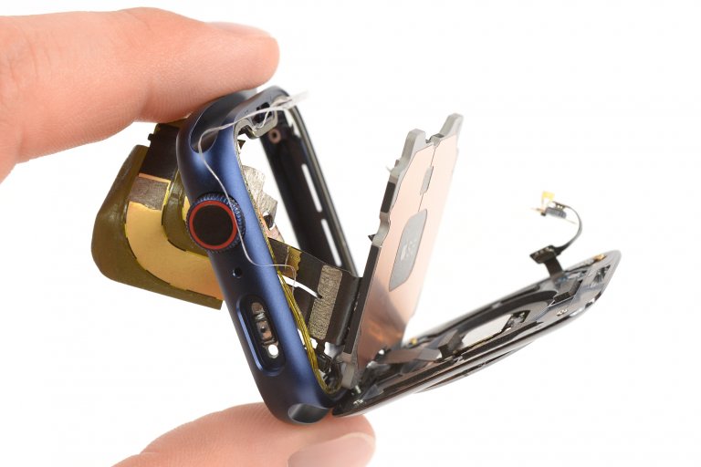 Fingers holding a Series 6 Apple Watch with the screens fanned out
