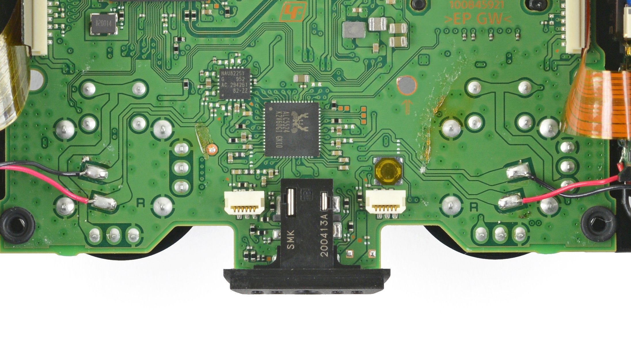 View of the backside of a PS5 controller, with board exposed.