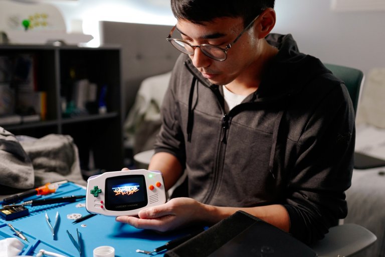Bernard Capulong, holding up modded Game Boy Advance